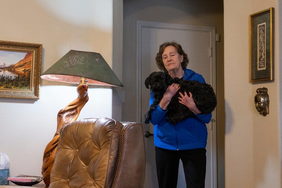 Patricia Turner holds her dog, Chet, at her home in Hutto, after it was attacked inside the house by a stray dog.