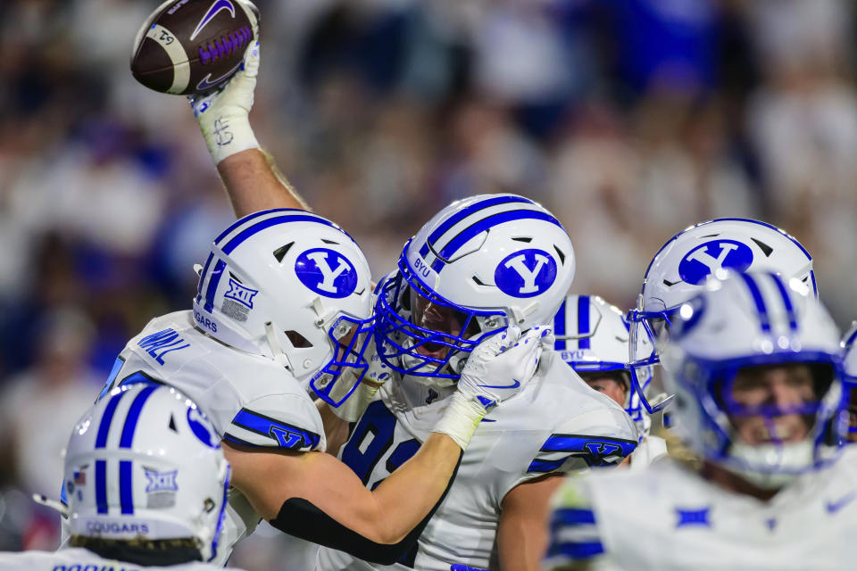 BYU defensive end Tyler Batty, center, celebrates his forced turnover with teammates during an NCAA college football game against Kansas State, Saturday, Sept. 21, 2024, in Provo, Utah. (AP Photo/Tyler Tate)