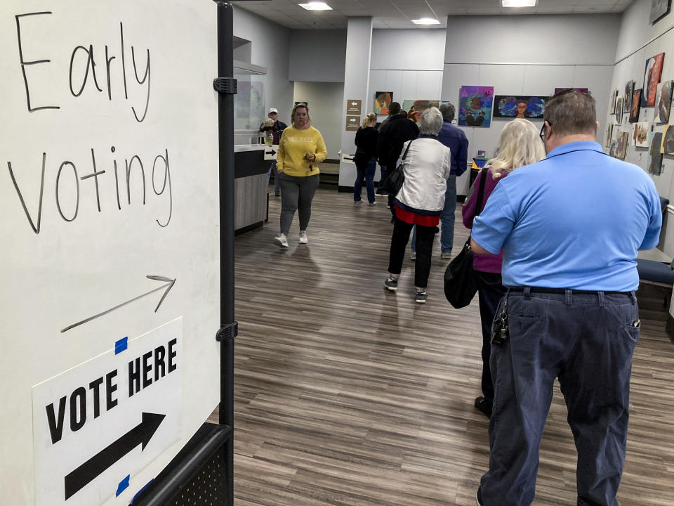 FILE - People wait in line to early vote Nov. 28, 2022, in Kennesaw, Ga. The nation's cybersecurity agency is launching a program aimed at boosting election security in the states, shoring up support for local offices and hoping to provide reassurance to voters that this year's presidential elections will be safe and accurate. (AP Photo/Mike Stewart, File)