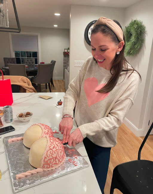 Julie cutting a boob cake for her 