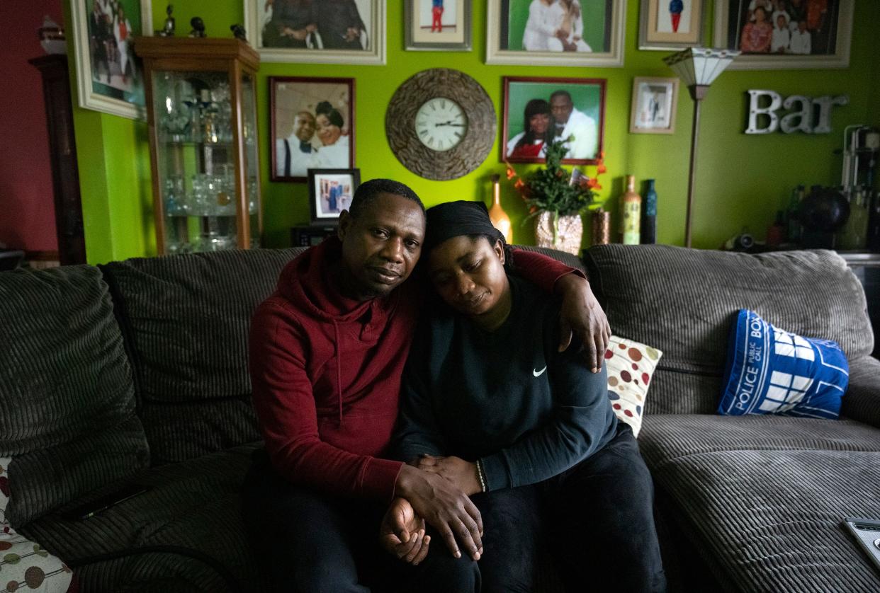 Frank and Henrietta Debrah sit in their living room on the Northeast Side surrounded by family photos. Their son Kofi Debrah, an 11th grader at Westerville North High School, died by suicide the day after a team of Columbus police officers raided their home on a warrant that indicated he was a “person of interest” in a crime.