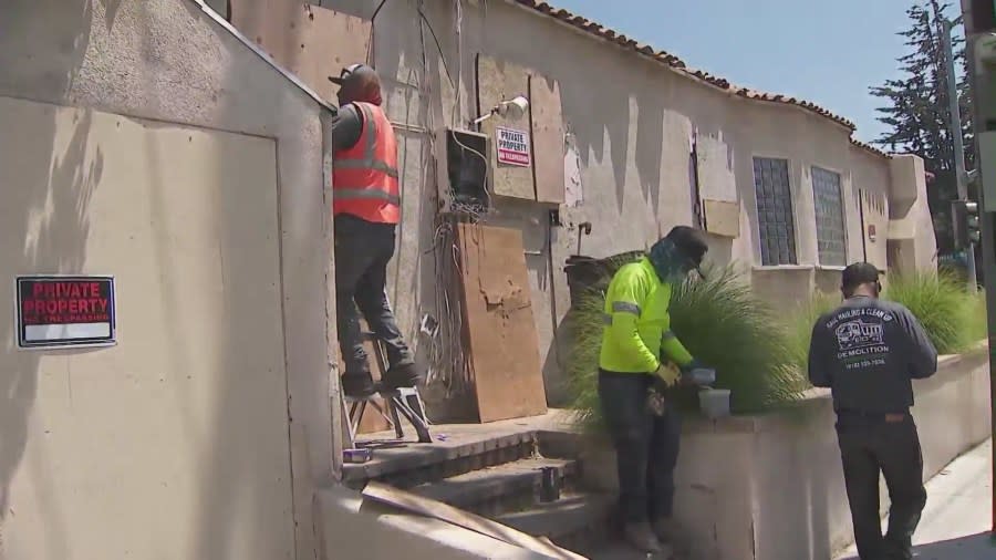 Workers boarding up a West Hollywood home on July 2, 2024 after complaints of squatters constantly trespassing. (KTLA)