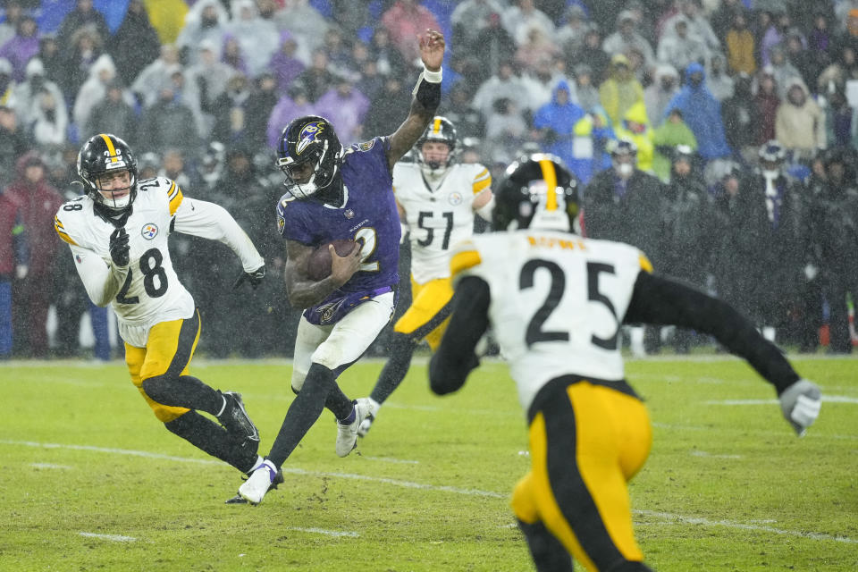 Baltimore Ravens quarterback Tyler Huntley (2) runs with the ball as Pittsburgh Steelers safety Miles Killebrew (28), defensive tackle linebacker Nick Herbig (51) and safety Eric Rowe (25) try to stop him during the second half of an NFL football game, Saturday, Jan. 6, 2024 in Baltimore. (AP Photo/Matt Rourke)