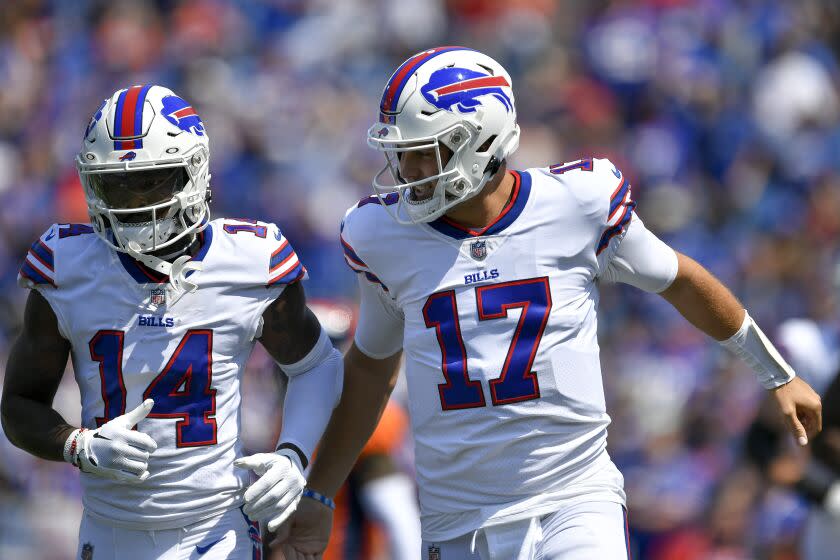 Buffalo Bills quarterback Josh Allen, right, and wide receiver Stefon Diggs run off the field during the first half of a preseason NFL football game against the Denver Broncos in Orchard Park, N.Y., Saturday, Aug. 20, 2022. (AP Photo/Adrian Kraus)