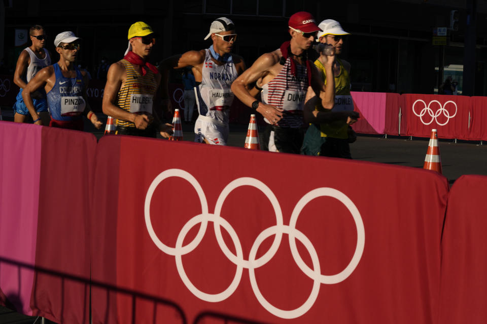Canada's Evan Dunfee, front right, Germany's Jonathan Hilbert, fourth from right, and Norway's Havard Haukenes, third from right, and others compete in the men's 50km race walk at the 2020 Summer Olympics, Friday, Aug. 6, 2021, in Sapporo, Japan. (AP Photo/Shuji Kajiyama)