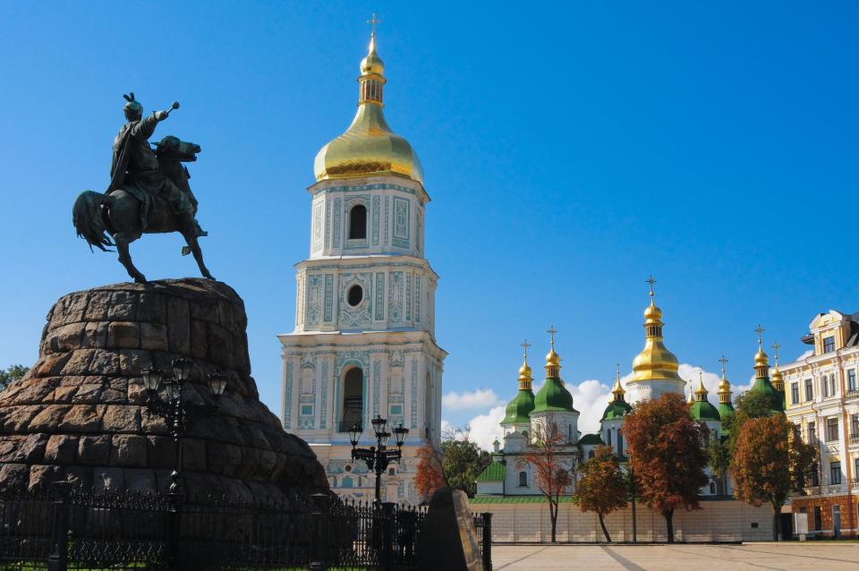 Gold onion domes of the St. Sophia Cathedral and its bell tower, dating back to the 11th century, and the monument to hetman Bohdan Khmelnitsky in central Kyiv. (Getty Images)