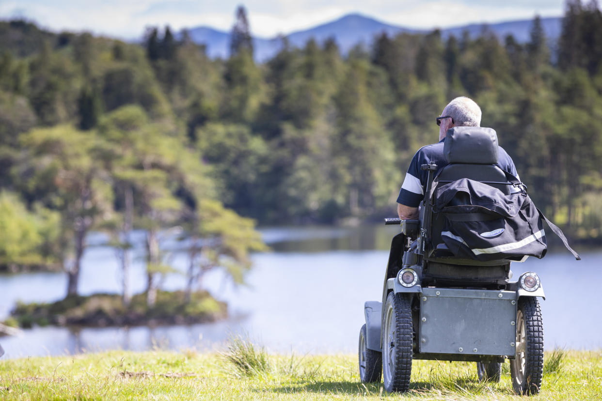 Visitor enjoying the view of the lake at Tarn Hows, Cumbria (Chris Lacey/National Trust)