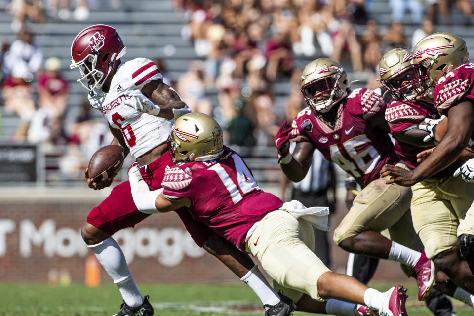 Florida State defensive end Marcus Cushnie (14) drags down a scrambling Massachusetts quarterback Zamar Wise (6) in the second half of an NCAA college football game in Tallahassee, Fla., Saturday, Oct. 23, 2021. Florida State defeated UMass 59-3. (AP Photo/Mark Wallheiser)