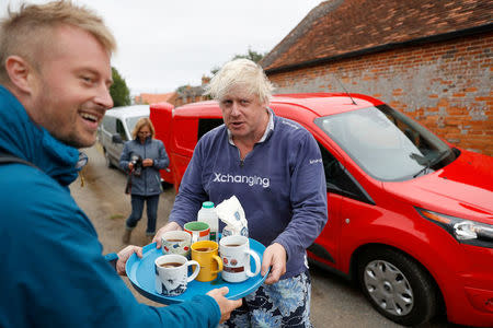 Britain's former Foreign Secretary Boris Johnson offers cups of tea to journalists outside his home near Thame in Oxfordshire, August 12, 2018. REUTERS/Peter Nicholls