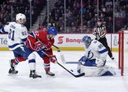 Apr 2, 2019; Montreal, Quebec, CAN; Tampa Bay Lightning goalie Edward Pasquale (80) stops a shot by Montreal Canadiens forward Artturi Lehkonen (62) while Erik Cernak (81) defends during the third period at the Bell Centre. Mandatory Credit: Eric Bolte-USA TODAY Sports