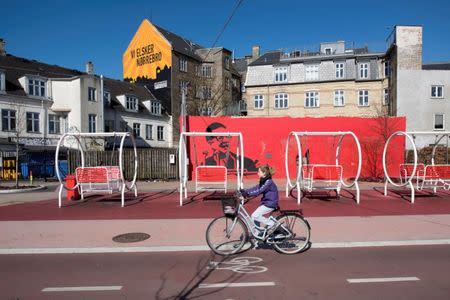 A girl rides a bicycle at Superkilen park in Copenhagen, Denmark April 22, 2016. Picture taken April 22, 2016. Aga Khan Award for Architecture/Handout via REUTERS