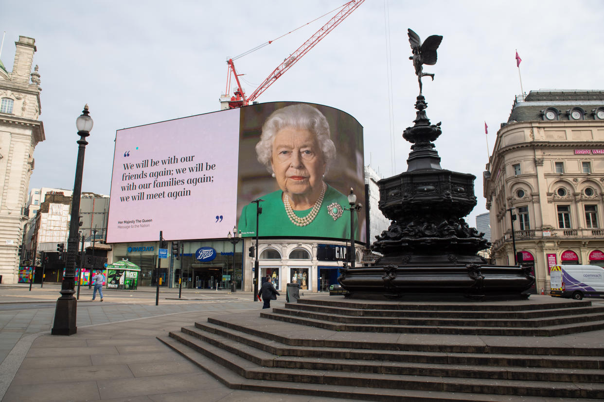 An image of Queen Elizabeth II and quotes from her broadcast on Sunday to the UK and the Commonwealth in relation to the coronavirus epidemic are displayed on lights in London's Piccadilly Circus. (Photo by Dominic Lipinski/PA Images via Getty Images)