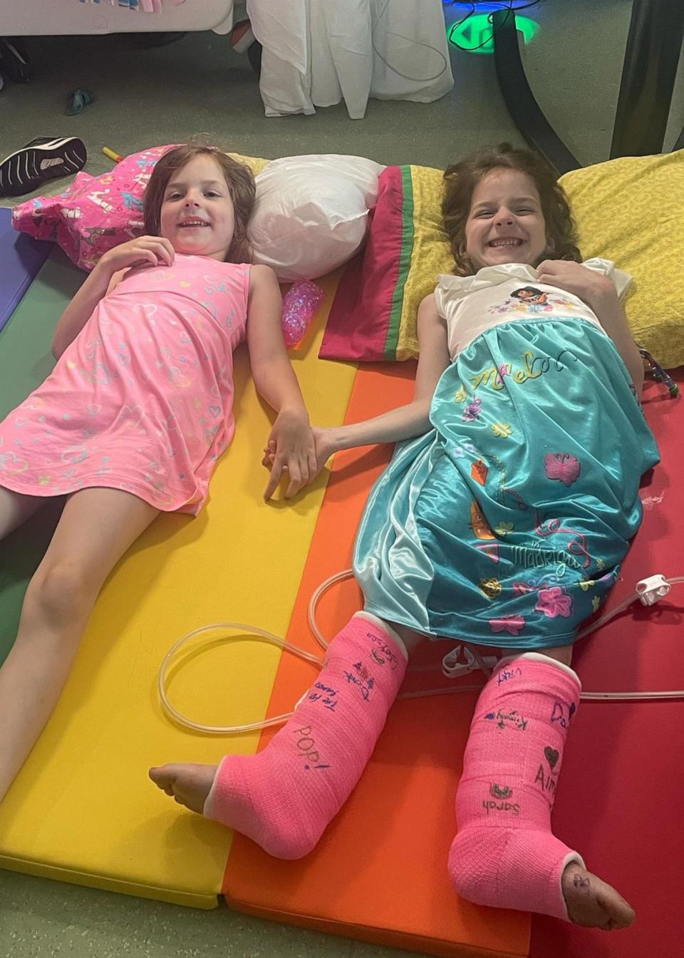 PHOTO: Aubrey Scaletta, right, lays on a recovery mat with her twin sister, Grayson. (The Scaletta Family)