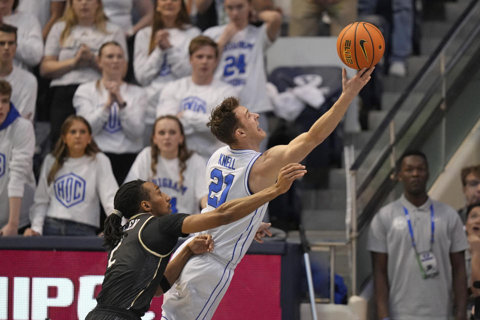 BYU guard Trevin Knell (21) goes to the basket as Central Florida guard Shemarri Allen (2) defends during the first half of an NCAA college basketball game Tuesday, Feb. 13, 2024, in Provo, Utah. (AP Photo/Rick Bowmer)