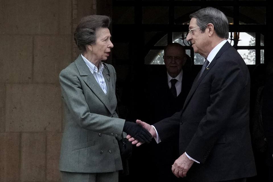 Cyprus' President Nicos Anastasiades and Britain's Princess Anne, left, shake hands after a meeting at the presidential palace in Nicosia, Cyprus, Wednesday, Jan. 11, 2023. Princess Anne visited British soldiers serving with a United Nations peacekeeping force on ethnically divided Cyprus. (AP Photo/Petros Karadjias)