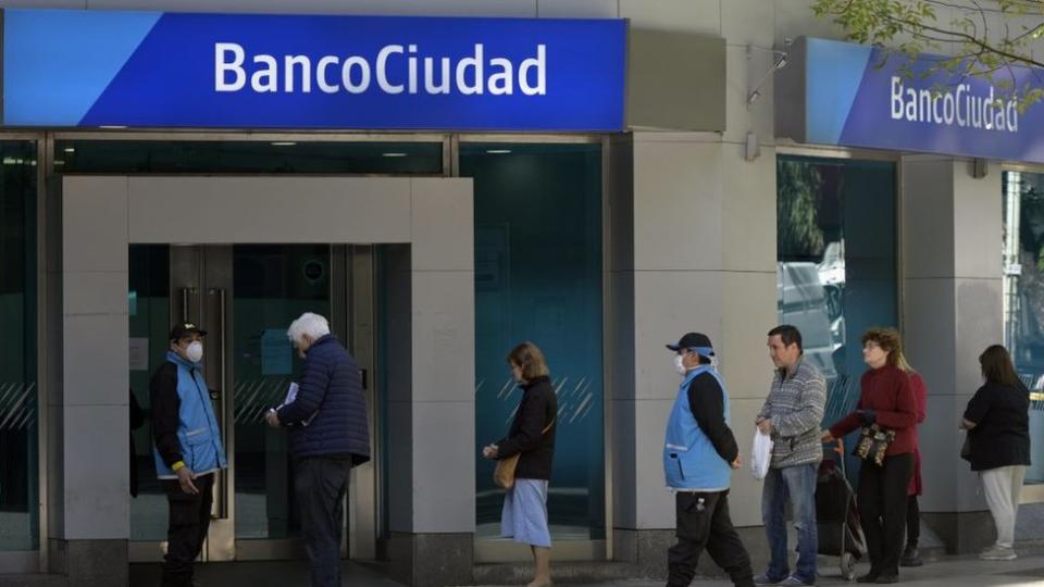 Gente haciendo fila en un banco...