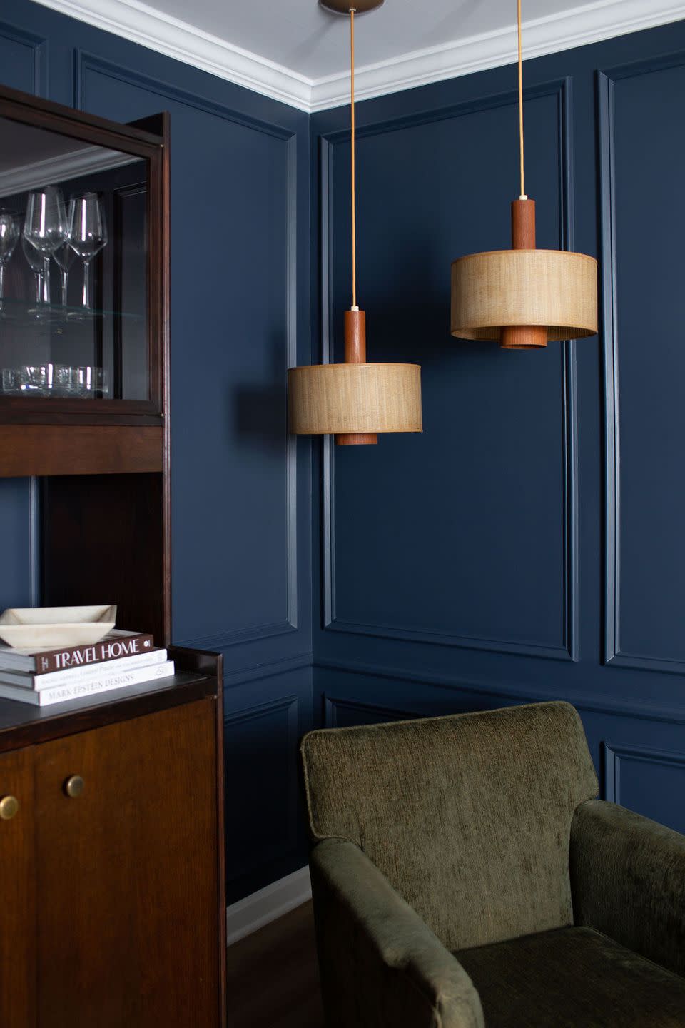 a blue cabinet with a lamp and a chair in front of it