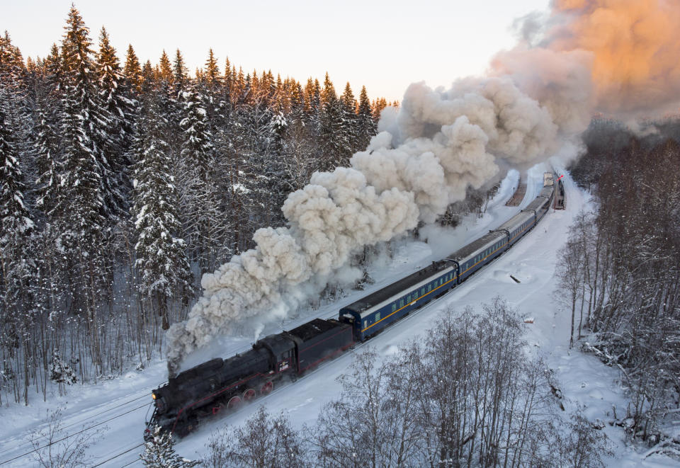 A Soviet-era steam locomotive pulls a retro train taking tourists to the Ruskeala natural park from the city of Sortavala, Karelia region, Russia. Russia’s rollout of its coronavirus vaccine is only now picking up speed in some of its more remote regions. The experts blame the slow rollout on limited supplies of the vaccine, logistical difficulties in distribution and continued hesitance among some Russians. (AP Photo/Dmitri Lovetsky, File)