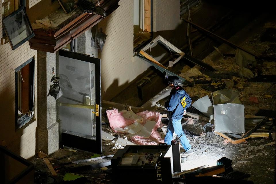 An official surveys an area near the back entrance to the Sandman Signature hotel following an explosion, Monday, Jan. 8, 2024, in Fort Worth, Texas.