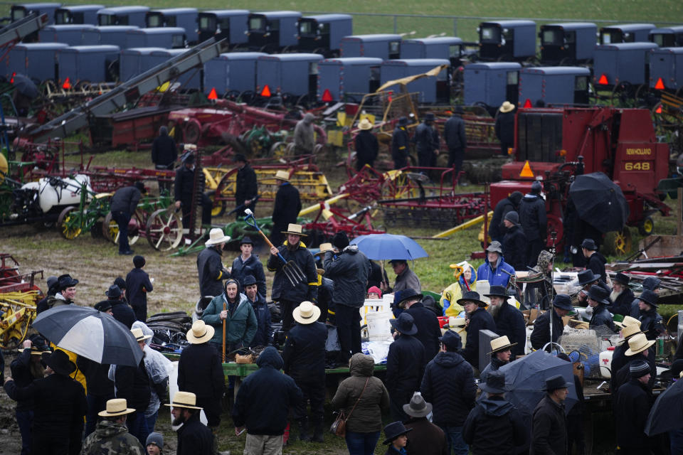 An auctioneer takes bids for farm equipment during the 56th annual mud sale to benefit the local fire department in Gordonville, Pa., Saturday, March 9, 2024. Mud sales are a relatively new tradition in the heart of Pennsylvania's Amish country, going back about 60 years and held in early spring as the ground begins to thaw but it's too early for much farm work. (AP Photo/Matt Rourke)