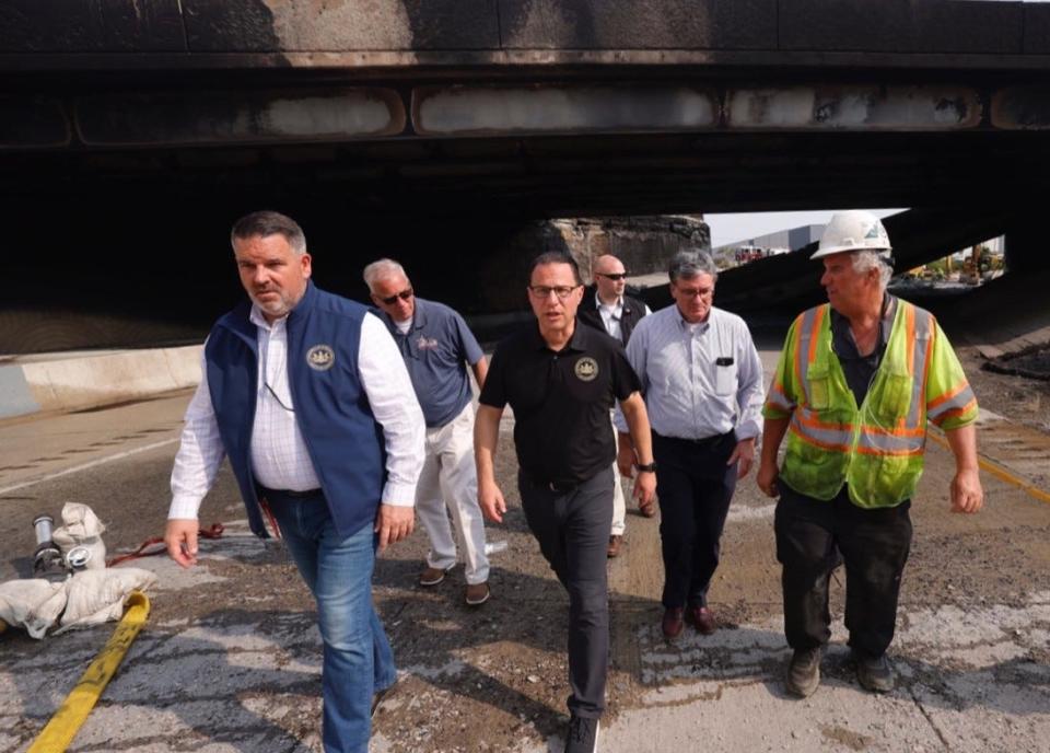 Pennsylvania Gov. Josh Shapiro and other officials walk at the scene of an overpass collapse in Northeast Philadelphia on Sunday.