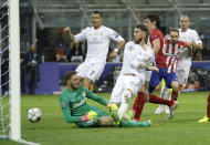 FILE - In this Saturday, May 28, 2016 file photo Real Madrid's Sergio Ramos, center, scores his side's first goal during the Champions League final soccer match between Real Madrid and Atletico Madrid at the San Siro stadium in Milan, Italy. O is for Offside. Many finals have thrown up controversial moments, but the admission by match referee Mark Clattenburg that Real Madrid's crucial opener in the 2016 Champions League final should have been ruled out for offside was one of the biggest. It was doubly galling for crosstown rivals Atletico who went on to lose the match on penalties, as they had fallen agonizingly close against the Real in the final in 2014 as well. (AP Photo/Andrew Medichini, File)