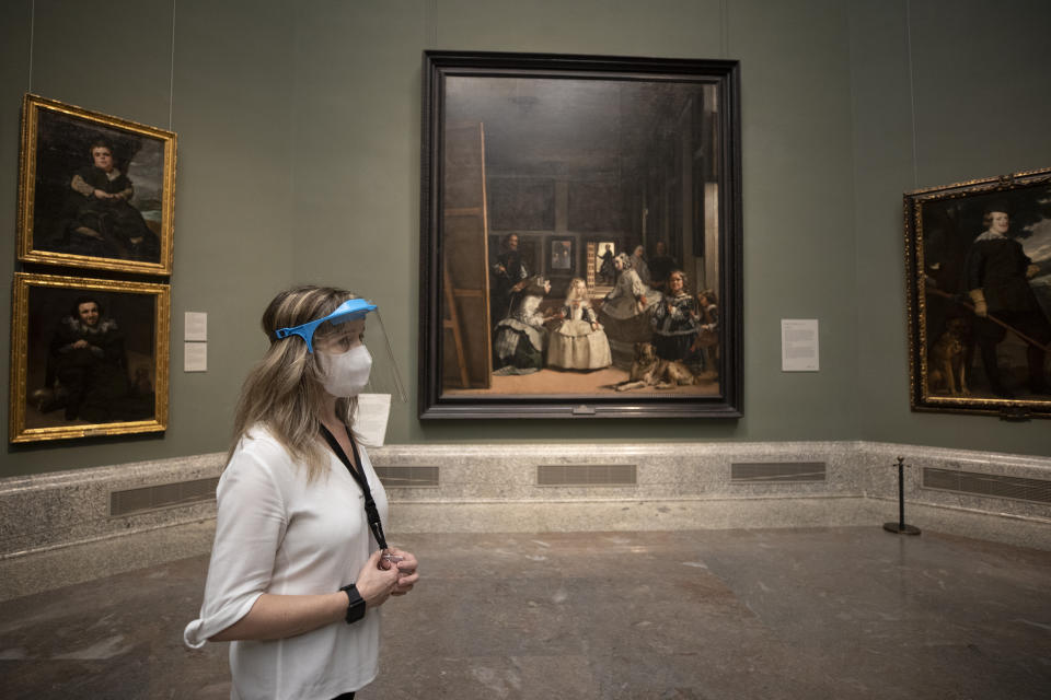 A staff member of the museum stands in front of 'Las Meninas' by Diego de Velazquez before the reopening on June 6 amid the coronavirus disease (COVID-19) outbreak at El Prado museum in Madrid, Spain, Thursday, June 4, 2020. Three of Madrid's most famous museums are set to reopen on June 6 as Spain winds down its restrictions on movement due to the new coronavirus. (AP Photo/Manu Fernandez)