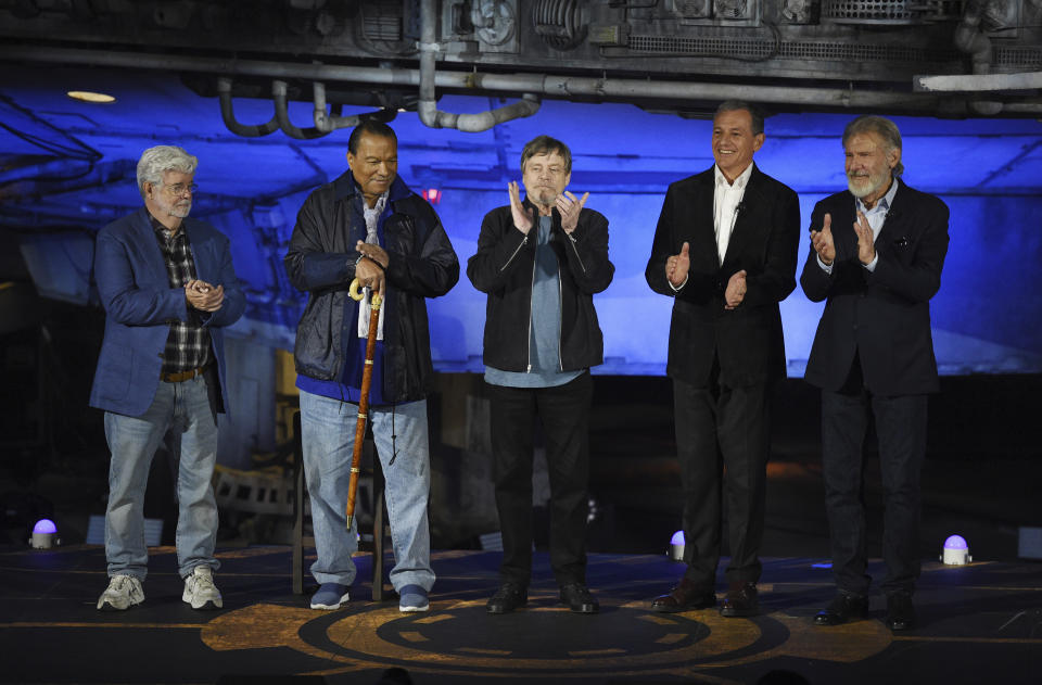 From left, "Star Wars" franchise creator George Lucas, cast members Billy Dee Williams and Mark Hamill, Walt Disney Co. Chairman and CEO Bob Iger and cast member Harrison Ford applaud onstage at a dedication ceremony in front of the Millennium Falcon during the Star Wars: Galaxy's Edge Media Preview at Disneyland Park, Wednesday, May 29, 2019, in Anaheim, Calif. (Photo by Chris Pizzello/Invision/AP)