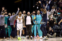 Memphis Grizzlies forward Jaren Jackson Jr., right, reacts with teammates after a win against the Denver Nuggets in an NBA basketball game Wednesday, Nov. 3, 2021, in Memphis, Tenn. (AP Photo/Brandon Dill)