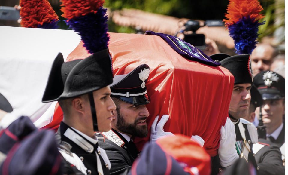 The coffin containing the body of the Carabinieri's officer Mario Cerciello Rega is carried during his funeral in his hometown of Somma Vesuviana, near Naples, southern Italy, Monday, July 29, 2019. Two American teenagers were jailed in Rome on Saturday as authorities investigate their alleged roles in the fatal stabbing of the Italian police officer on a street near their hotel. (Cesare Abbate/ANSA via AP)