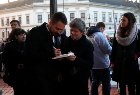 Chairman of the Hungarian right wing opposition party Jobbik Gabor Vona signs autographs after a campaign forum in Nagykanizsa, Hungary, March 16, 2018. REUTERS/Bernadett Szabo