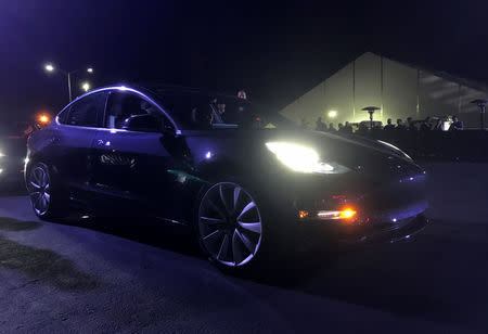 Customer employees receive some of the first Model 3 cars off the Fremont factory's production line during an event at the company's facilities in Fremont, California, U.S., July 28, 2017. REUTERS/Alexandria Sage