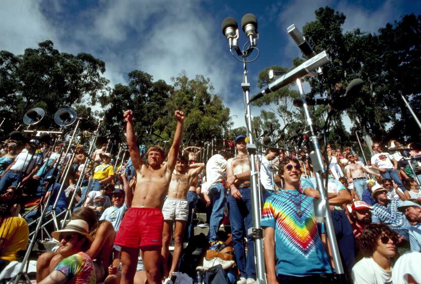 Concertgoers stand and cheer amongst microphones being used to record a Grateful Dead show in Berkeley, Calif. in 1987.