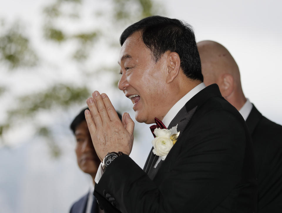 Former Thai Prime Minister Thaksin Shinawatra welcomes guests for the wedding of his youngest daughter Paetongtarn "Ing" Shinawatra at a hotel in Hong Kong, Friday, March 22, 2019. (AP Photo/Kin Cheung)