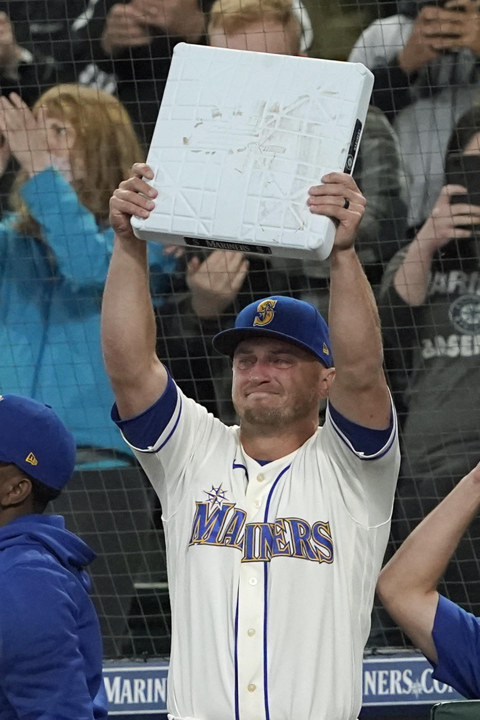 Seattle Mariners third baseman Kyle Seager holds up third base after it was given to him when he was subbed out of a baseball game against the Los Angeles Angels during the ninth inning, Sunday, Oct. 3, 2021, in Seattle. (AP Photo/Ted S. Warren)