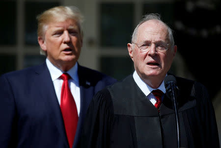 FILE PHOTO: U.S. President Donald Trump listens as Justice Anthony Kennedy speaks before swearing in Judge Neil Gorsuch as an Associate Supreme Court Justice in the Rose Garden of the White House in Washington, U.S. on April 10, 2017. REUTERS/Joshua Roberts/File Photo