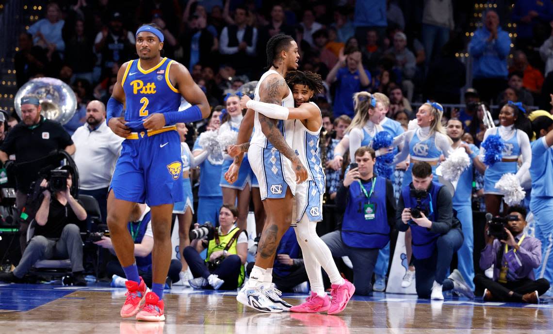 North Carolina’s RJ Davis (4) and Armando Bacot (5) hug as time runs out in UNC’s 72-65 victory over Pitt in the semifinals of the 2024 ACC Men’s Basketball Tournament at Capital One Arena in Washington, D.C., Friday, March 15, 2024.
