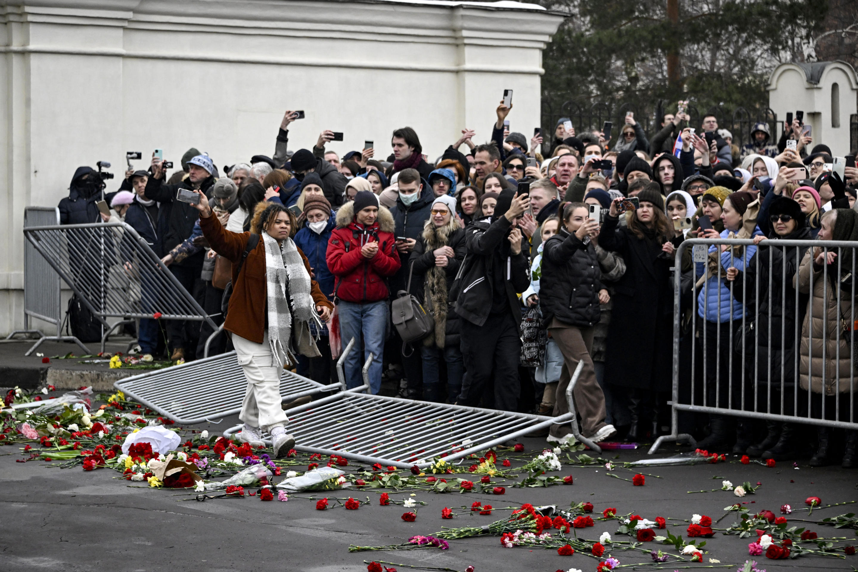 Mourners knock over a barrier outside the funeral in Moscow Friday.