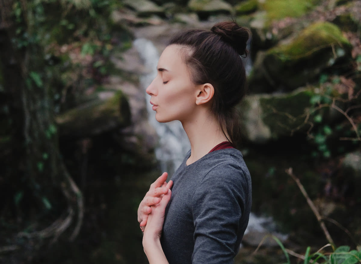 woman doing breathing exercises to manage stress