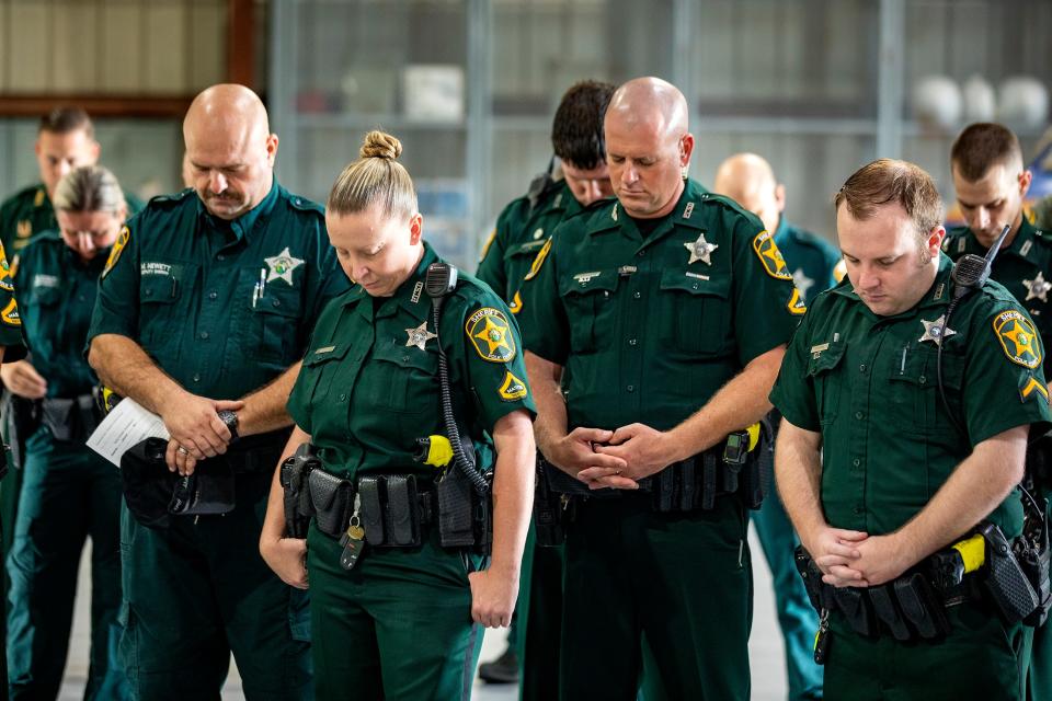 Polk County sheriff's personnel say a prayer before leaving Bartow to help with Hurricane Idalia aftermath in Levy County in August. The Sheriff's Office hopes to add 25 deputies per year for the next five years to deal with explosive growth in Polk County.