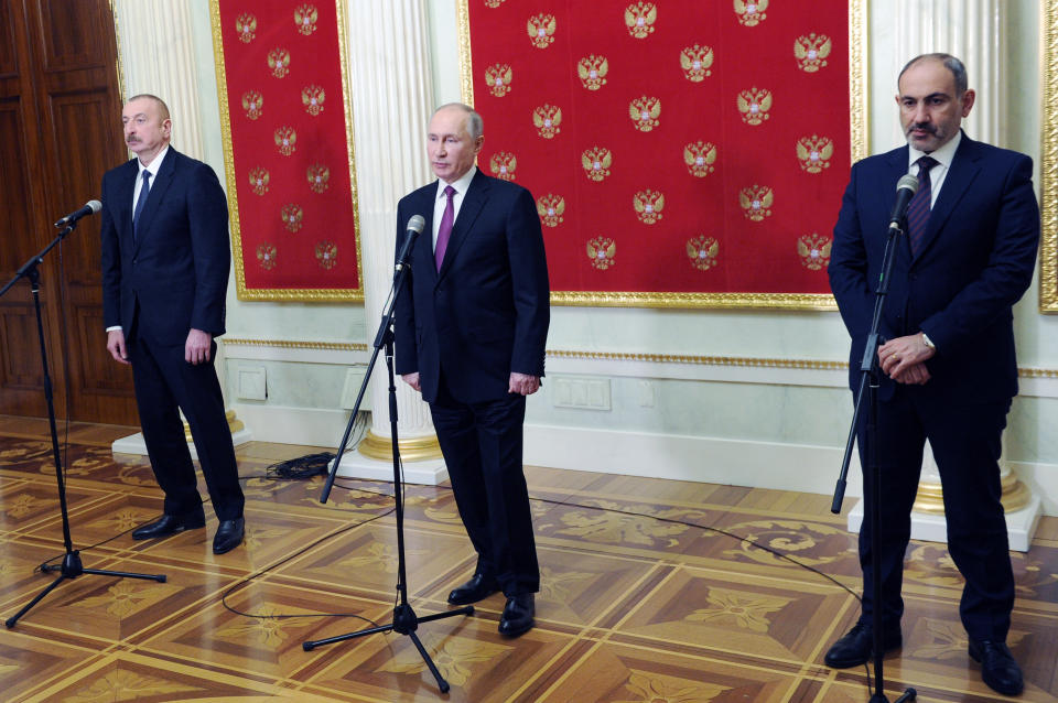 Russian President Vladimir Putin, center, Azerbaijan's President Ilham Aliyev, left, and Armenian Prime Minister Nikol Pashinyan speak to media after talks in Kremlin in Moscow, Russia, Monday, Jan. 11, 2021. Russian President Vladimir Putin on Monday hosted his counterparts from Armenia and Azerbaijan, their first meeting since a Russia-brokered truce ended six weeks of fighting over Nagorno-Karabakh. (Mikhail Klimentyev, Sputnik, Kremlin Pool Photo via AP)