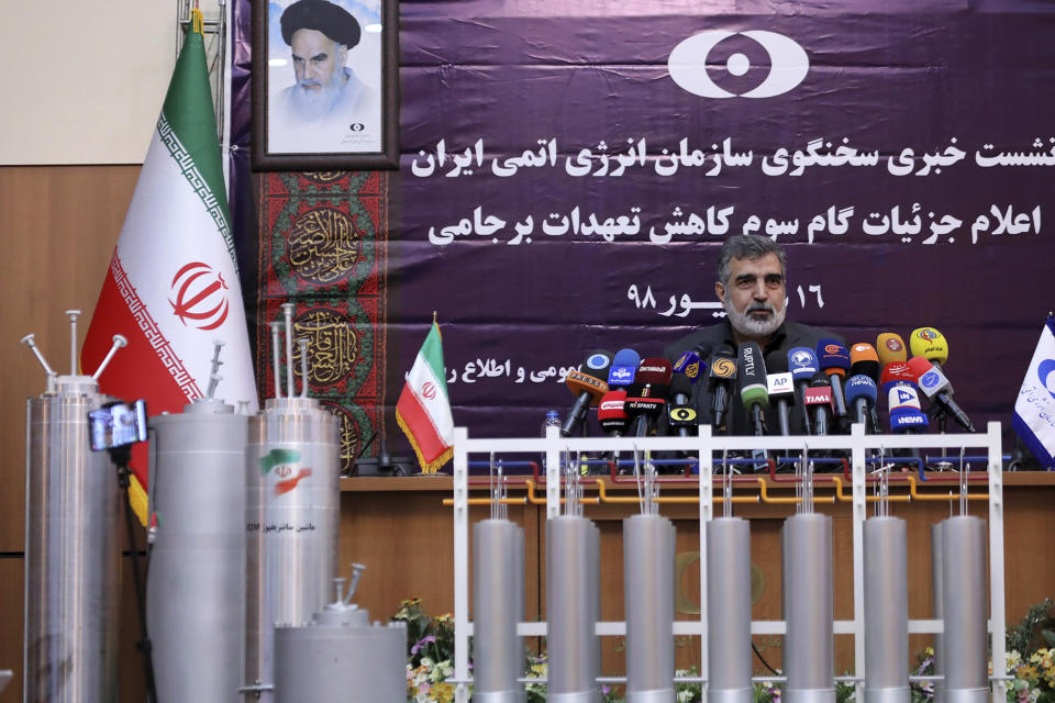 In this photo released by the Atomic Energy Organization of Iran, spokesman of the organization Behrouz Kamalvandi speaks in a news briefing as advanced centrifuges are displayed in front of him, in Tehran, Iran, Saturday, Sept. 7, 2019. Iran has begun injecting uranium gas into advanced centrifuges in violation of its 2015 nuclear deal with world powers, Kamalvandi said. (Atomic Energy Organization of Iran via AP)