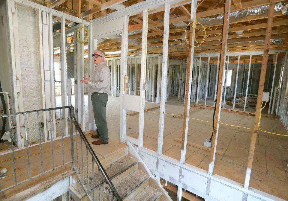 Fred Berry, president and CEO of Humility of Mary Housing, looks over unfinished reconstruction Wednesday at the charity's fire-damaged apartment building on Treeside Drive in Northwest Akron.