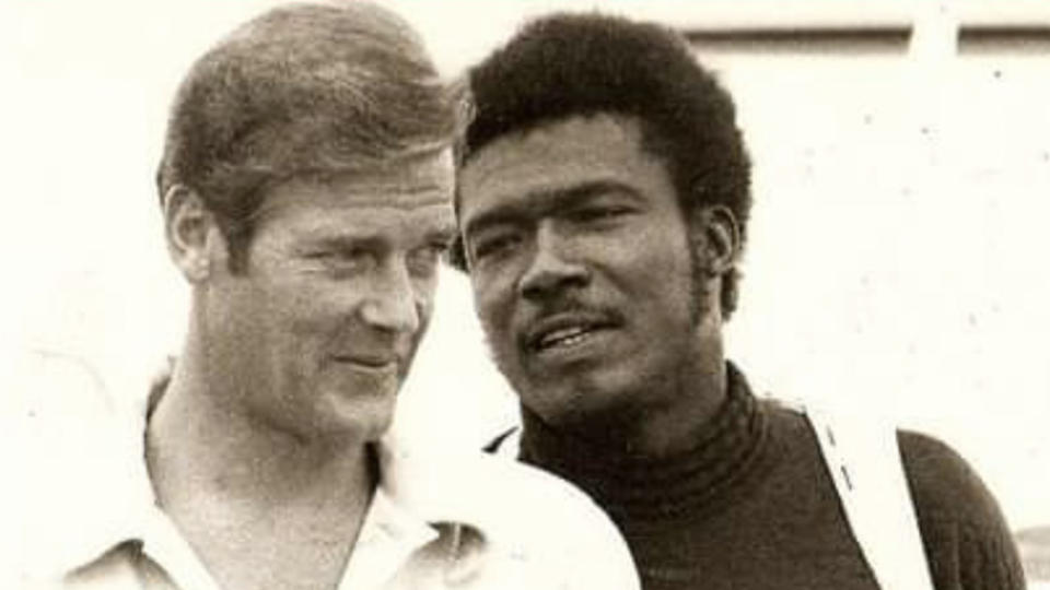 Roger Moore with Tommy Lane during the shooting of “Live and Let Die” - Credit: Courtesy of Kamala Lane