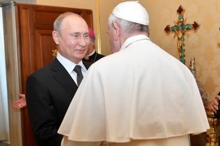 Russian President Vladimir Putin meets Pope Francis at the Vatican