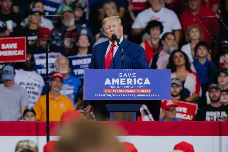 Former President Donald Trump stands at a podium as he speaks during a rally.