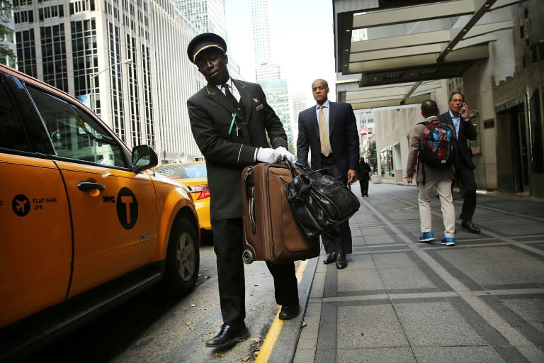 A hotel employee helps a guest with his bags at the Waldorf Astoria in New York