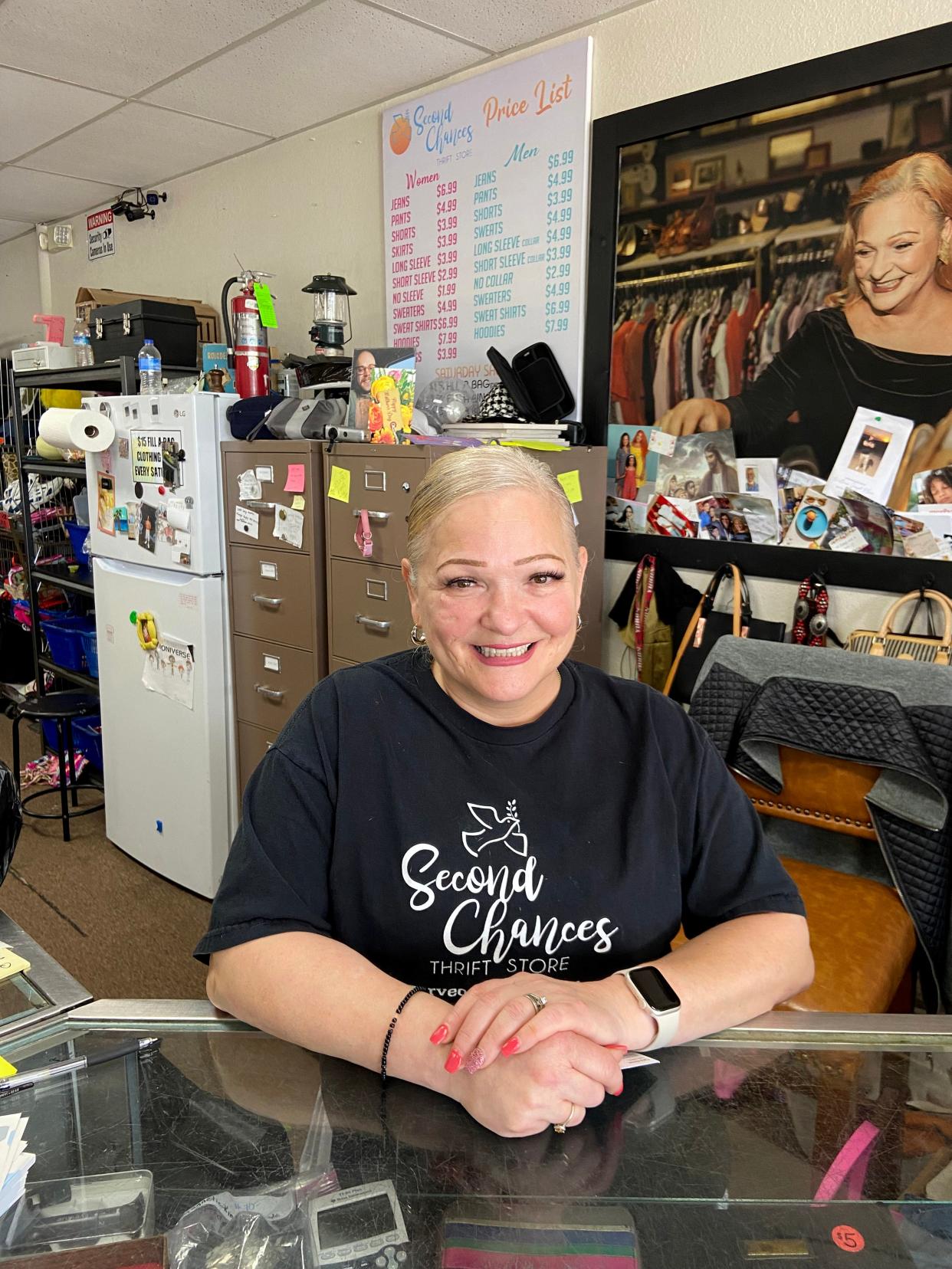 Delisa Jones, owner and founder of Second Chances Thrift Store ministry, stands recently at the counter of the ministry's Oklahoma City store at 2605 N MacArthur Blvd.