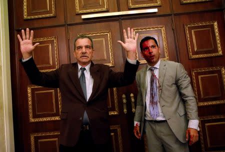 Opposition lawmaker Luis Stefanelli (L) gestures next to fellow opposition lawmaker Leonardo Regnault after a group of government supporters burst into Venezuela's opposition-controlled National Assembly during a session, in Caracas, Venezuela July 5, 2017. REUTERS/Carlos Garcia Rawlins