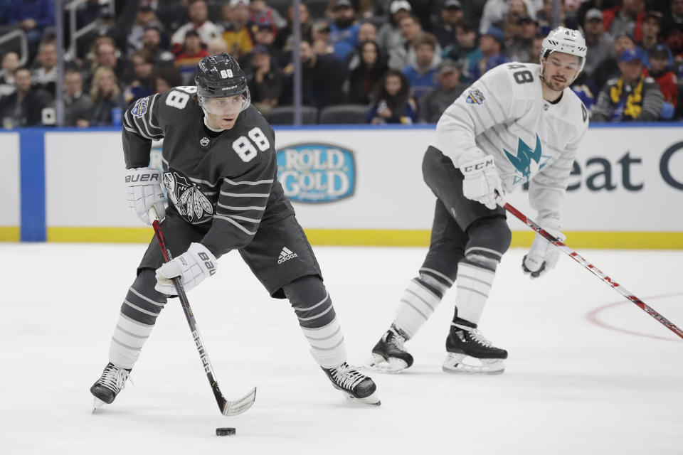 Chicago Blackhawks forward Patrick Kane (88) moves the puck against San Jose Sharks forward Tomas Hertl (48) in an NHL hockey All Star semifinal game Saturday, Jan. 25, 2020, in St. Louis. (AP Photo/Jeff Roberson)